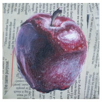 A close-up view of an acrylic painting titled 'The Apple.' The main focus is on a singular, highly textured apple depicted with deep, dark reds and glossy reflections. The apple is placed against a background of dull newspaper print, creating a striking contrast. Despite the absence of a shadow, the apple appears lifelike and vibrant. The painting measures 10x10cm and is part of a trio of decorative pieces.
