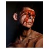 A captivating contemporary oil painting portrait depicting a young man with thick red paint covering his eyes and running down his face. The painting is titled 'Siren,' connecting the color red with themes of temptation, allure, and danger. The young man's obscured eyes add an element of mystery and intrigue to the artwork, while the flowing red paint symbolizes movement and fluidity.
