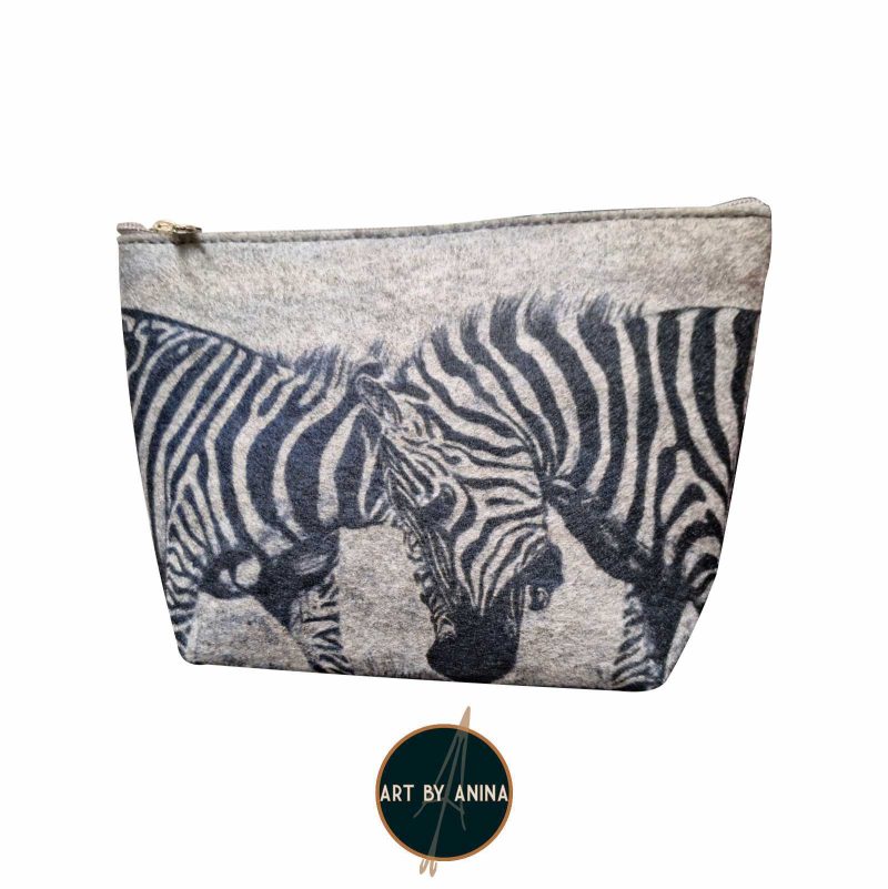 Product photo of a sustainable recycled cosmetic bag with two zebras fighting printed on it
